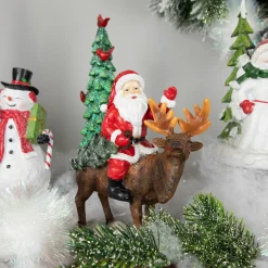 Santa Claus on a Reindeer Holding a Frosted Pine Tree Christmas Figurine - 8.25"